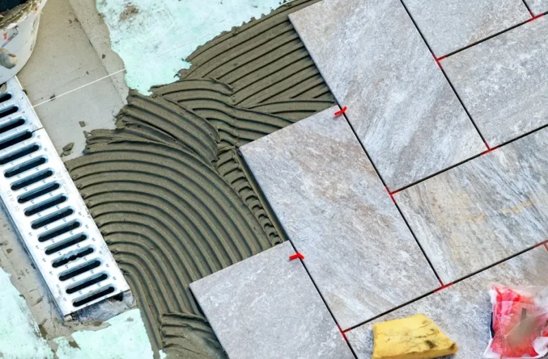 Ceramic tiles on adhesive with a stainless steel drain